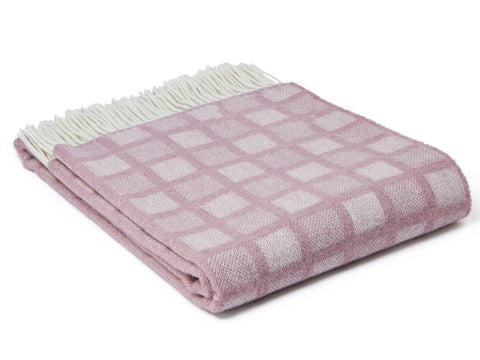 A soft lavender manhattan pure new wool throw with an intricate square pattern and cream-colored fringe perfect for cozying up
