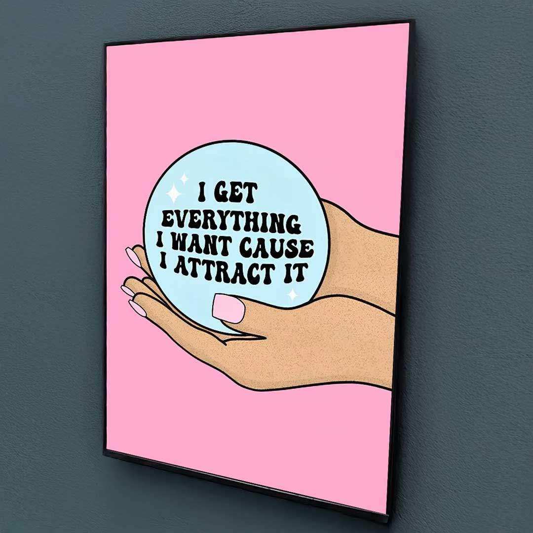 Pink-framed manifestation babe print with cartoon hand holding light blue crystal ball and black text design