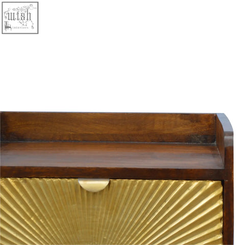 Dark wood bedside table with gold sunburst front panel and brass pull handle featuring nordic style legs manila gold