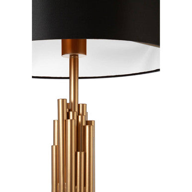 Manor table lamp with a sleek black drum shade and a brass tube base in an elegant cascading design