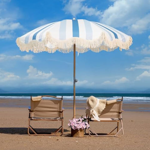 A stylish mansader garden umbrella parasol with white and light blue stripes cream fringe and a premium wood pole
