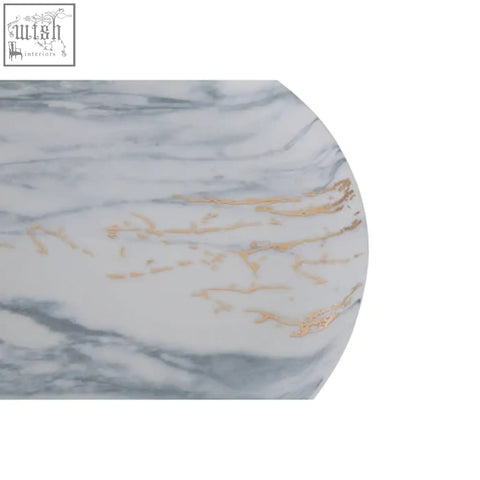 A marble luxe dinner plate with a white base, gray veining, and gold streaks for a luxe dinner look