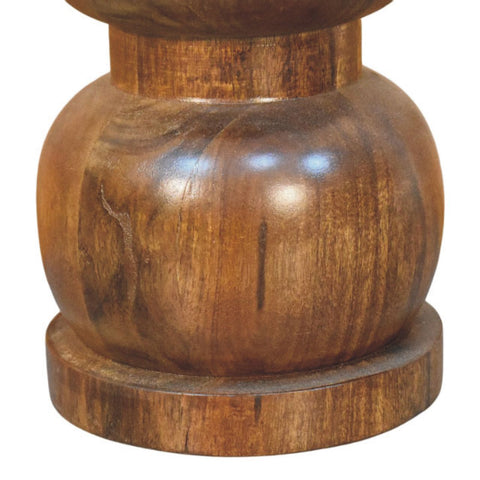 Polished dark brown wooden pepper mill with rounded bulbous body and glossy finish shown with marble top bulla side table