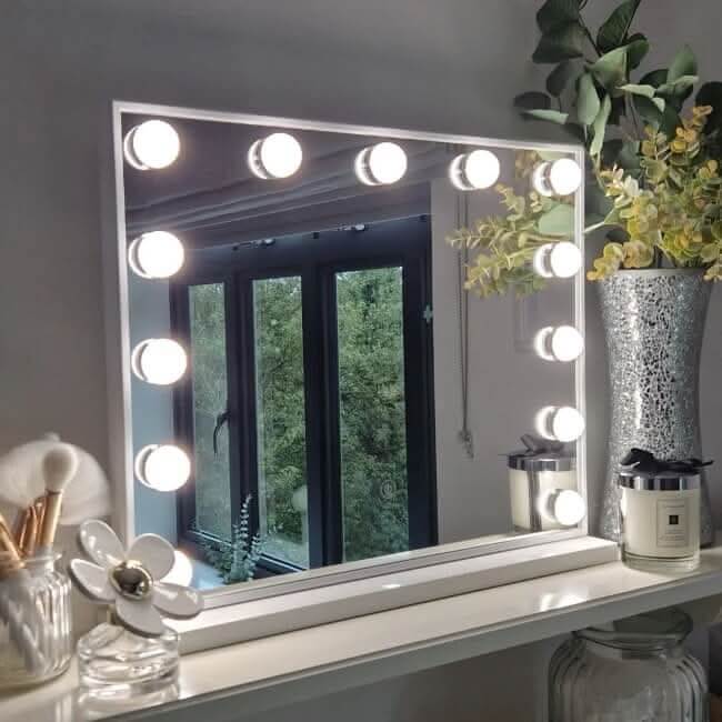 A sleek margot small hollywood mirror with a white frame and round led bulbs perfect for makeup and decor