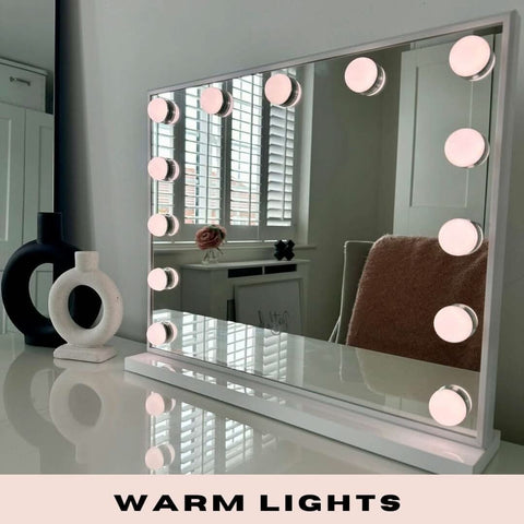A sleek white margot small hollywood mirror 50x42cm with warm circular lights along its frame perfect for makeup