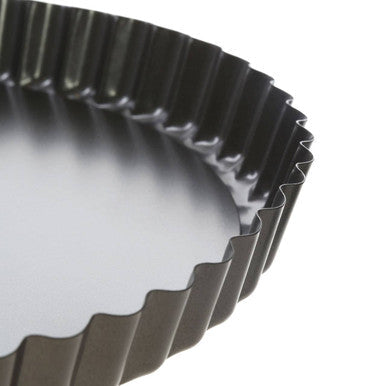 Black fluted metal 20xm loose base flan tin with smooth interior for easy baking and removal