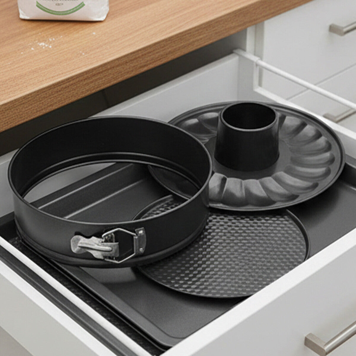 Black non-stick round cake pan set with silver buckle and matching tray perfect for baking round cakes