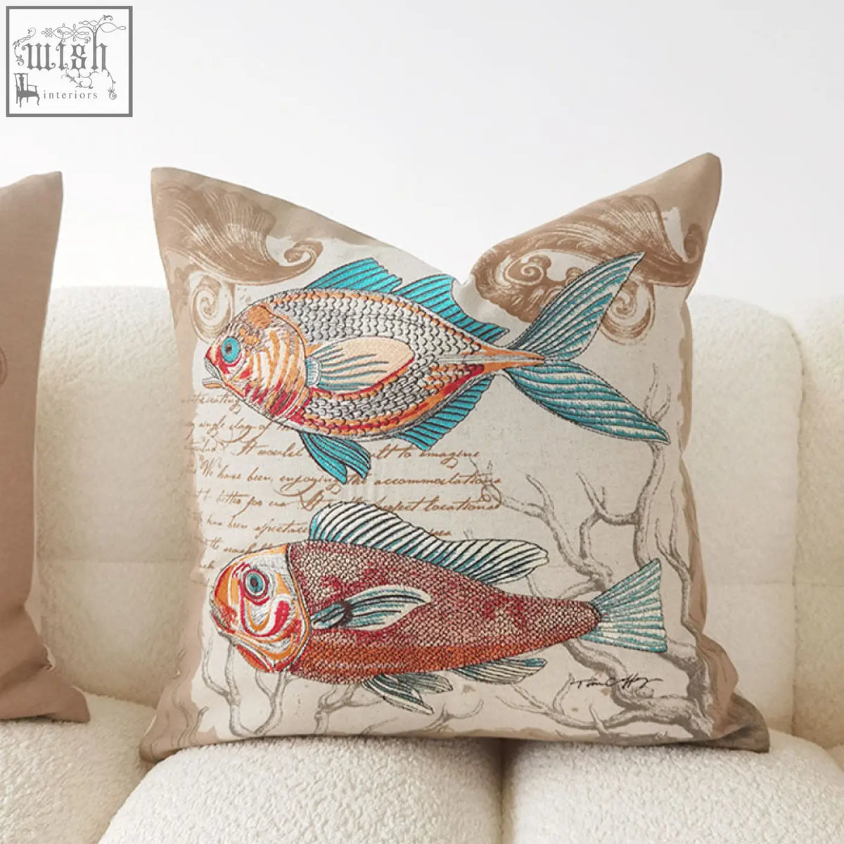 Beige marine cushion with embroidered orange red and teal fish on detailed fabric material with seaweed patterns