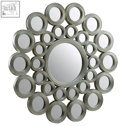 Maris silver wall mirror with silver-toned circular metallic frame featuring concentric decorative rings