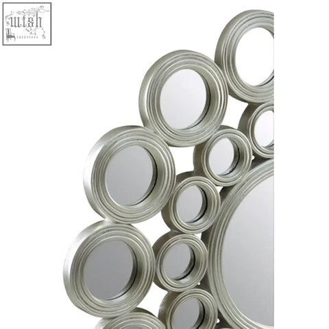 Maris silver wall mirror with a modern silver-toned circular design featuring layered concentric rings