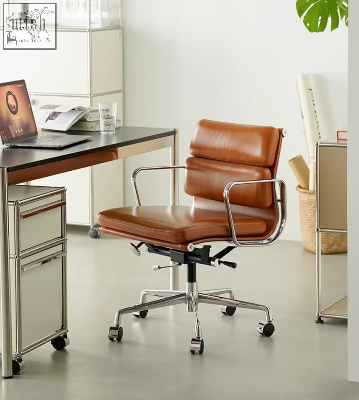 Brown leather office chair with chrome frame and swivel height adjustable features for a stylish office setup