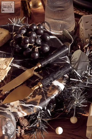 Black marble cake stand with gold-toned knife and spreader set perfect for serving marble cake or cheese board