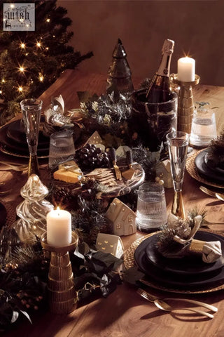 Black and gold festive table setting featuring marmore black and gold marble cake stand with elegant glassware