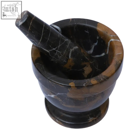 Black and brown gold marble mortar and pestle set made from natural gold marble for grinding and crushing herbs