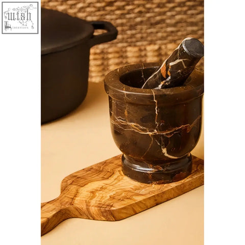 Dark brown marble mortar with swirling golden veins on wooden board perfect for gourmet grinding use