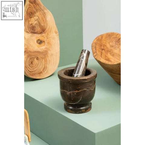 Dark brown marble mortar with polished stainless steel pestle inside marmore black and gold marble mortar and pestle