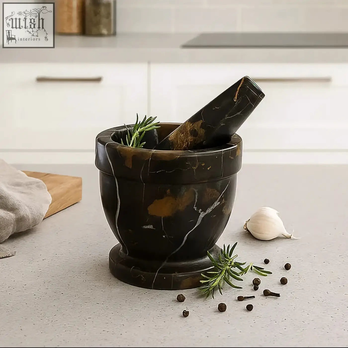 Dark brown marble mortar with white veining and rosemary with matching pestle from marmore black and gold marble mortar