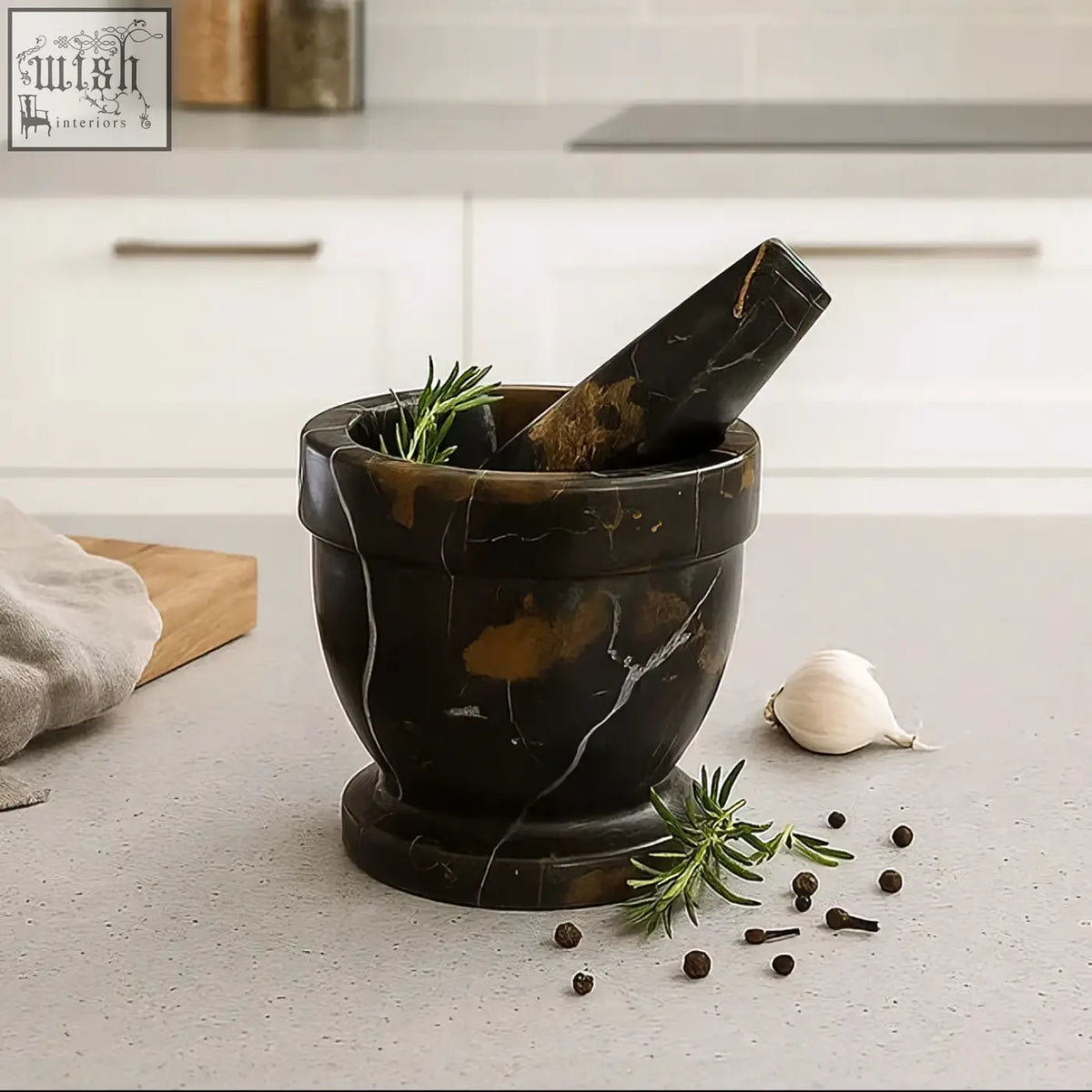 Dark brown marble mortar with white veining and rosemary with matching pestle from marmore black and gold marble mortar