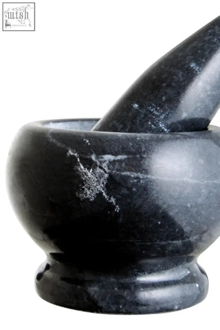 Black marble mortar and pestle set with smooth polished surface and gray veining from marmore black marble collection