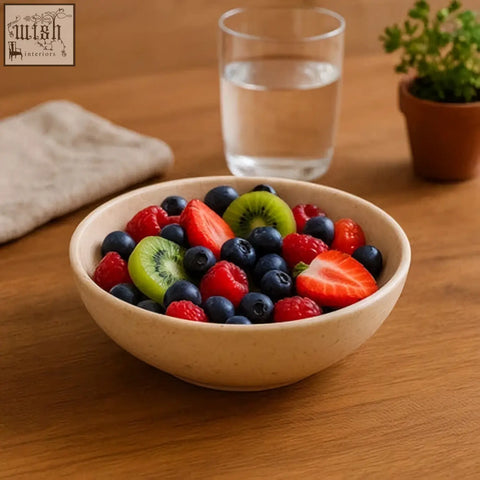 A beige marmore cream marble bowl filled with fresh berries and sliced kiwi for a colorful fruit display