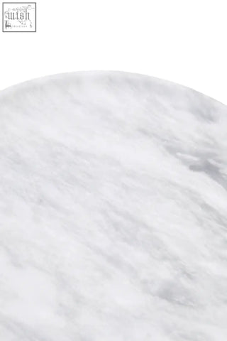 A marmore round marble plate with a circular white marble surface featuring subtle gray veining