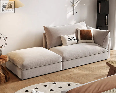Beige linen marquez two seater sofa with soft cushions and decorative pillows in a cozy sectional chaise lounge setup