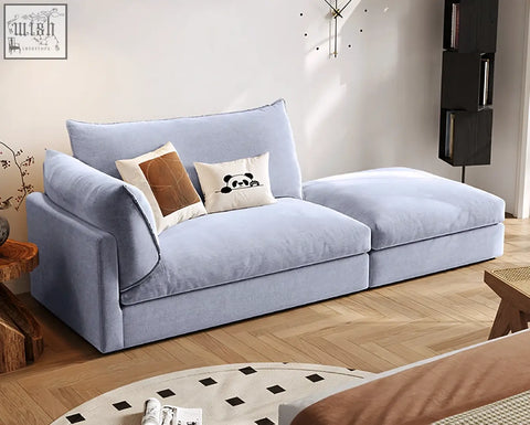 Light blue velvet marquez two seater sofa with plush cushions and decorative pillows perfect as a two seater sofa