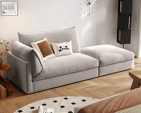 Modern gray velvet marquez two seater sofa with plush cushions and decorative pillows for cozy seating