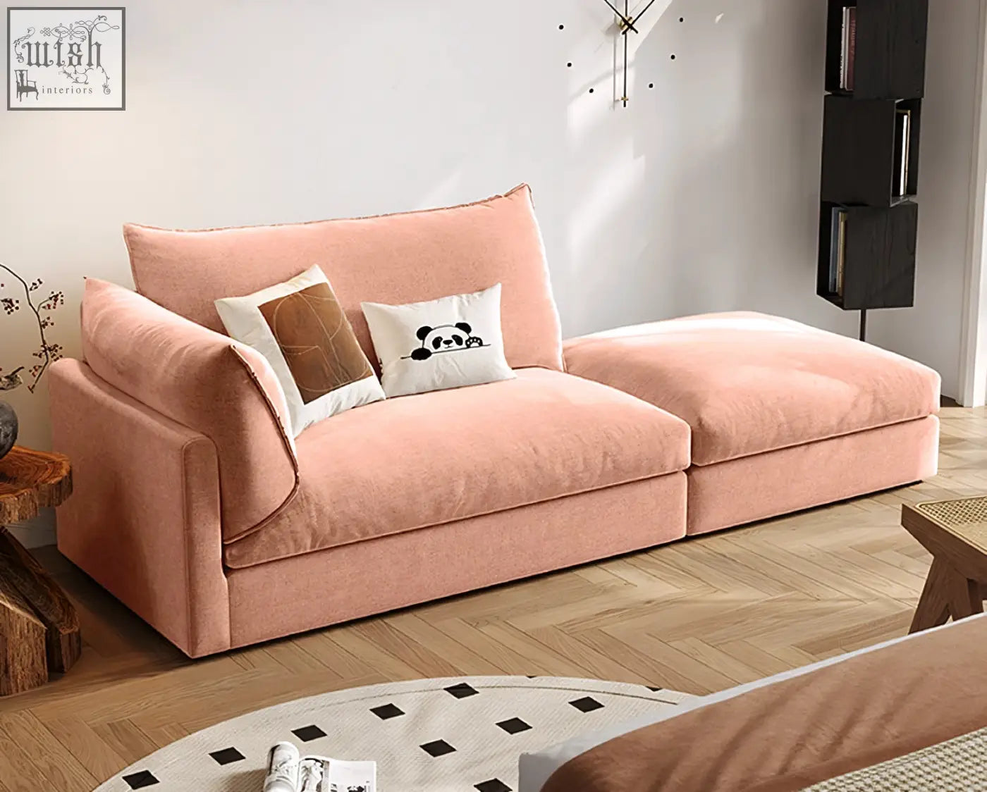 A blush pink velvet marquez two seater sofa with modern design and two decorative pillows