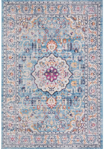A marrakech vintage area rug featuring faded blue and cream tones with intricate pink and purple floral patterns