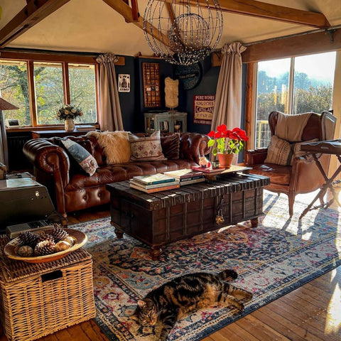 Brown leather chesterfield sofa with tufted upholstery and decorative pillows in a marrakech vintage setting