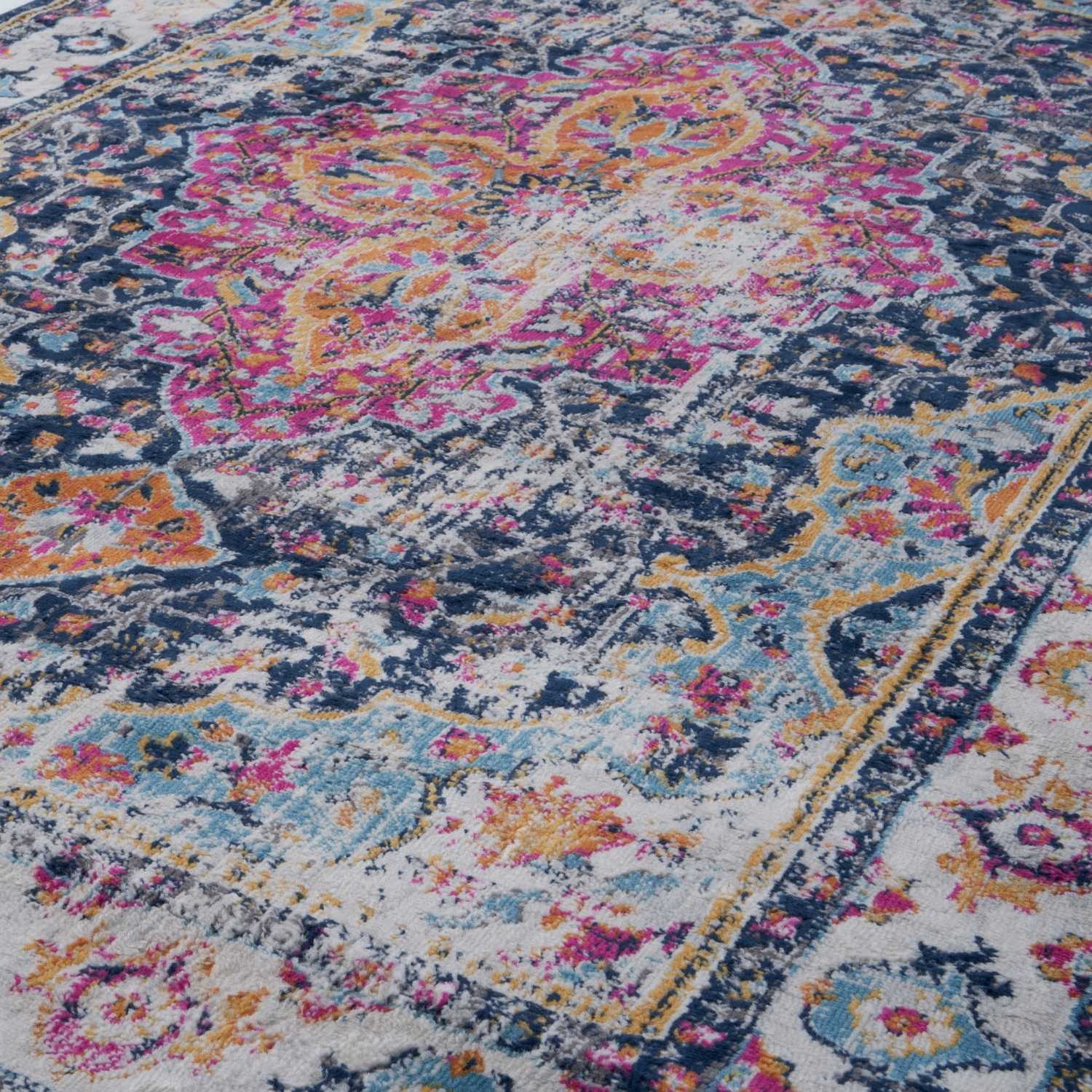 Vibrant marrakech vintage area rug with distressed floral and paisley patterns in pink orange blue on textured wool-like surface