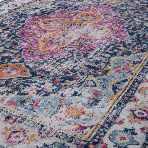 Vibrant marrakech vintage area rug with distressed floral and paisley patterns in pink orange blue on textured wool-like surface