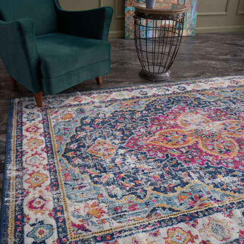 Vibrant distressed marrakech vintage area rug with intricate floral and geometric patterns in navy blue pink gold and cream