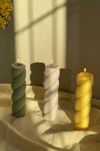 Three marshmallow shaped pillar candles in twisted sage green white and golden yellow perfect for decor