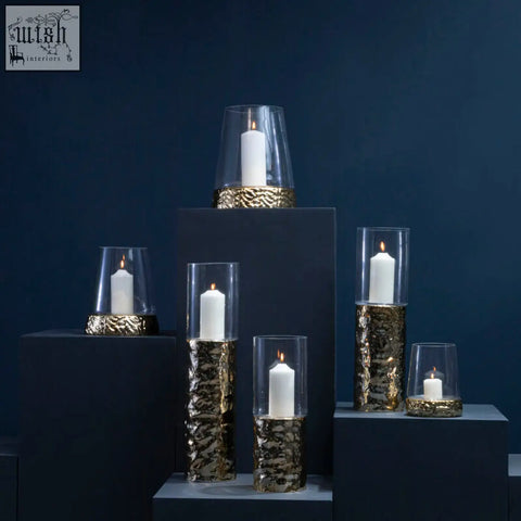 Martele medium piller gold candle holder with gold-leaf textured glass and clear tops holding white candles