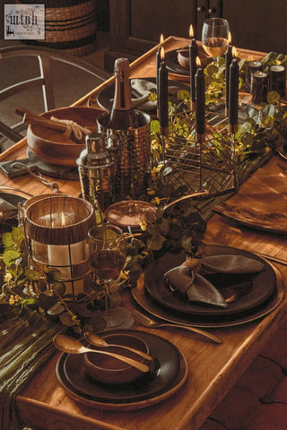 Dark brown ceramic hexagonal candle holder with matte finish paired with gold-toned cutlery for stylish decor