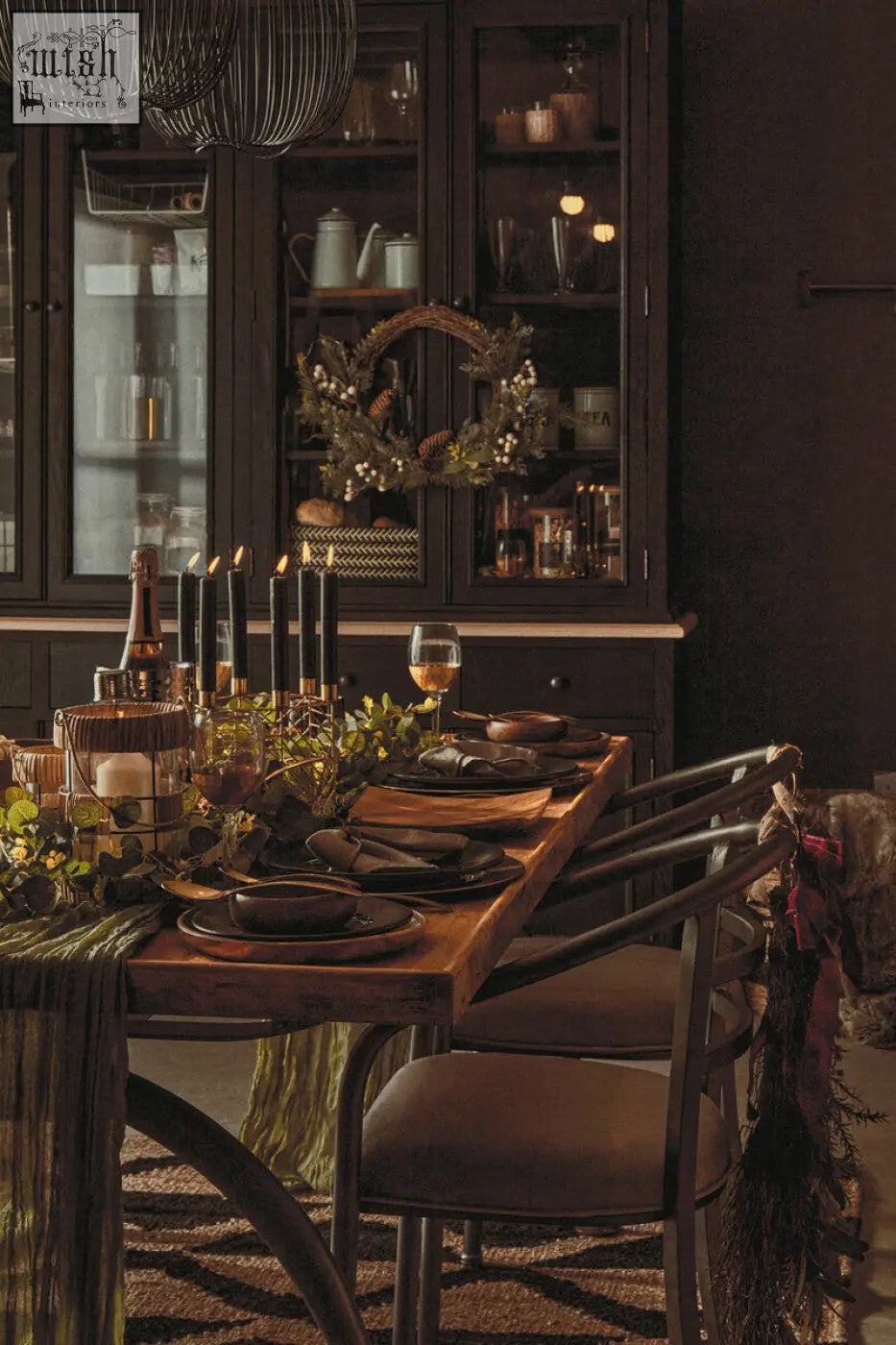 Dark wood dining table with rustic finish featuring a martina hexagonal candle holder and set place settings
