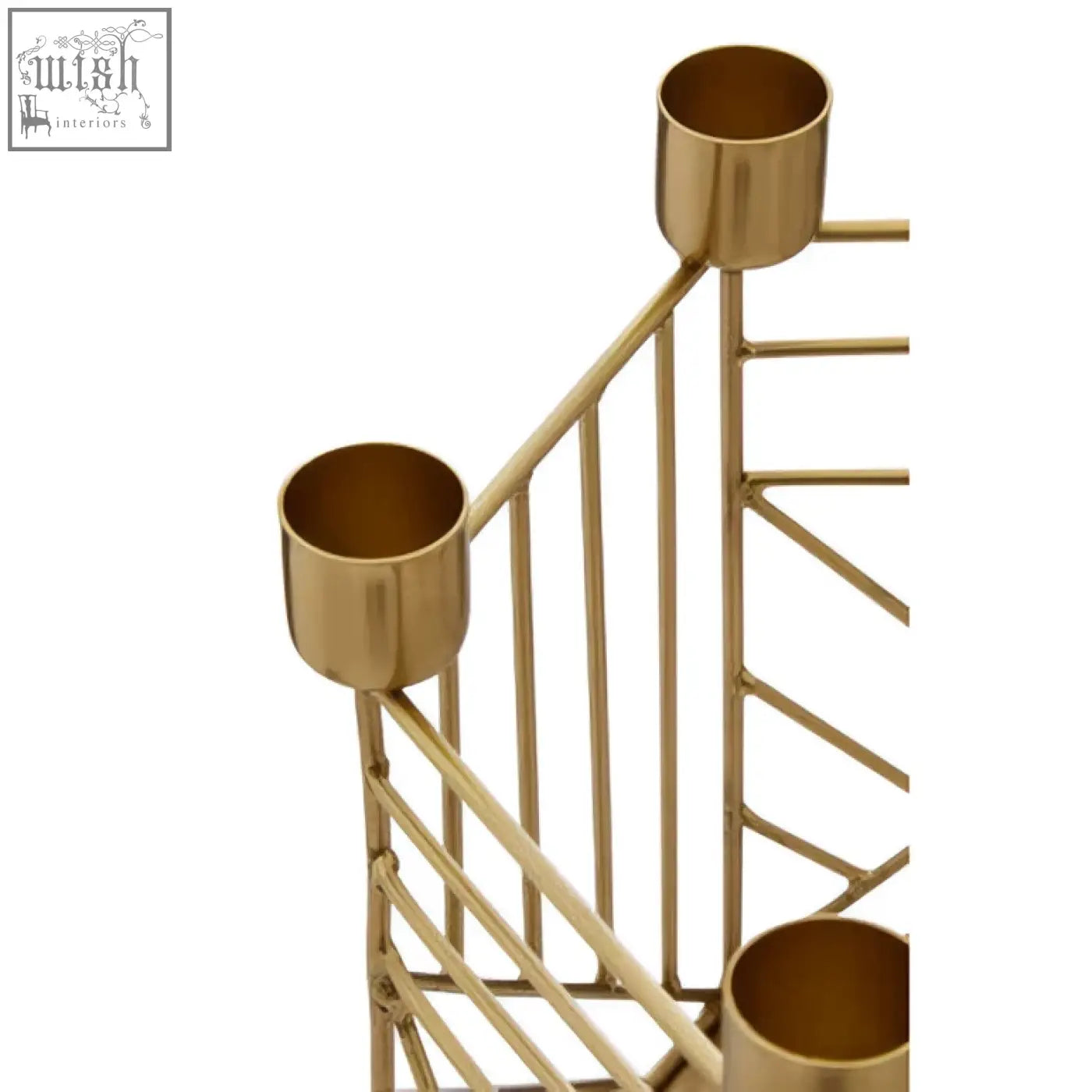 Gold-toned metal martina hexagonal candle holder with three cylindrical holders and angular geometric frame design