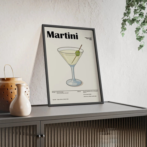 Black-framed martini cocktail poster with minimalist green olive illustration by small uk studio on off-white background