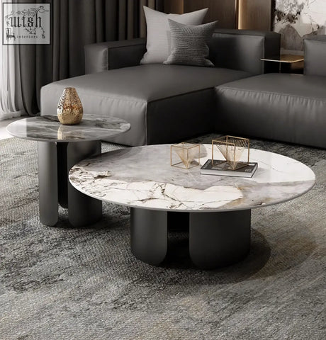 Modern oval coffee table with white gray marble top and black cylindrical legs from maru nesting coffee table set