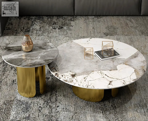 Modern round nesting coffee tables with polished white and gray marble tops and sleek gold cylindrical bases
