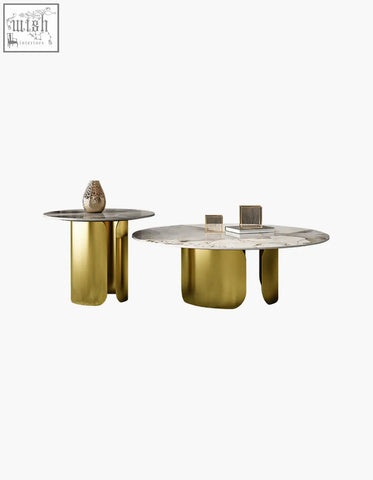Two modern nesting coffee tables with gold finished sculptural bases and sintered stone marble tops