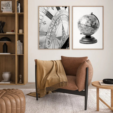 Brown upholstered armchair with black metal legs and tan fringed throw in a masculine wall art vintage sundial and globe set