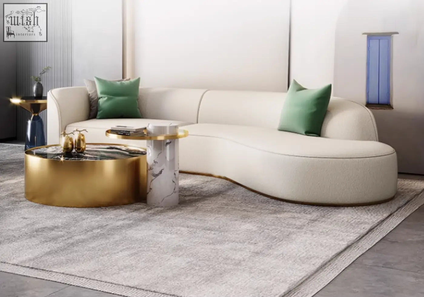 Cream-colored curved sectional sofa with green pillows paired with a mason marble coffee table set with marble coffee table