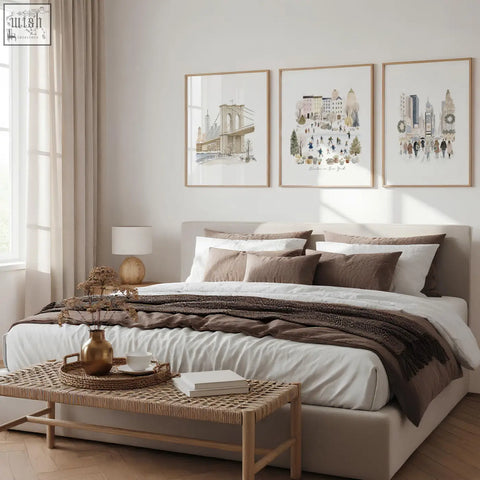 Beige upholstered bed with layered white and brown bedding below master bedroom art wall art prints winter in new york set of 3