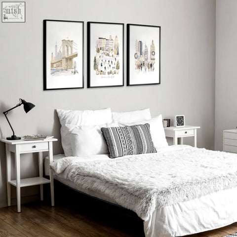 Set of three black-framed watercolor wall art prints featuring winter new york cityscapes perfect for master bedroom art