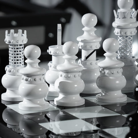 White ceramic masterpiece chess set with glossy finish and intricate detailing on the archtwain masterpiece chess table
