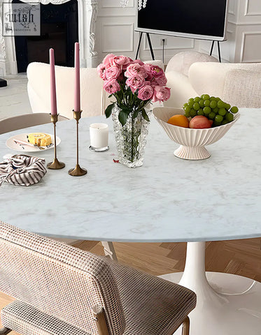 Crystal vase with pink roses on masuda oval dining table marble top perfect for elegant oval dining spaces