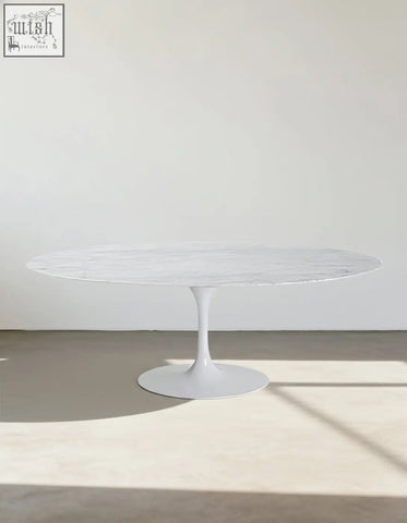 White marble-top masuda oval dining table with sleek minimalist pedestal base perfect for oval dining spaces